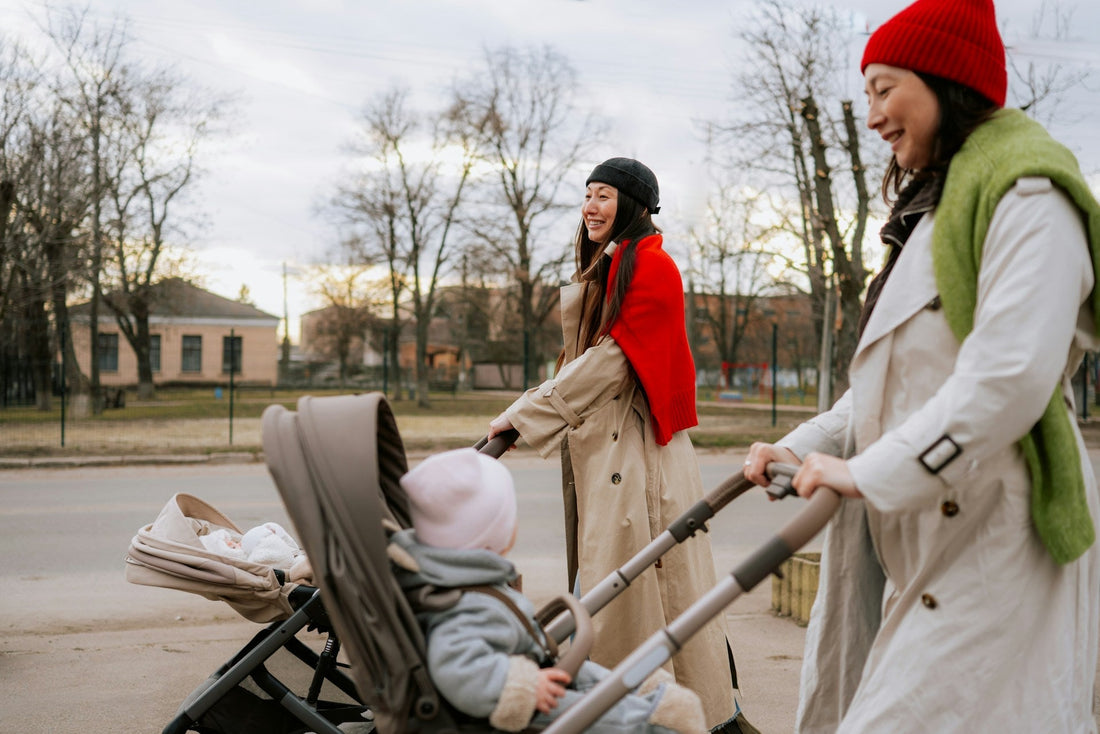 moms pushing strollers