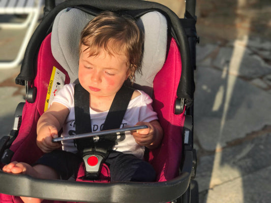 baby watching on a tablet while in stroller